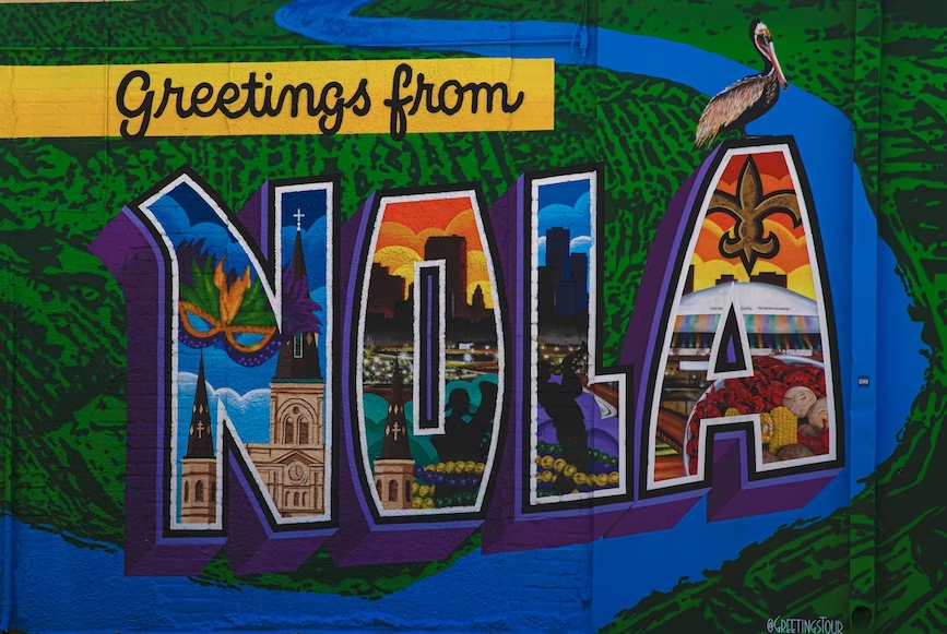 A close up of a mural that reads "Greetings from NOLA"